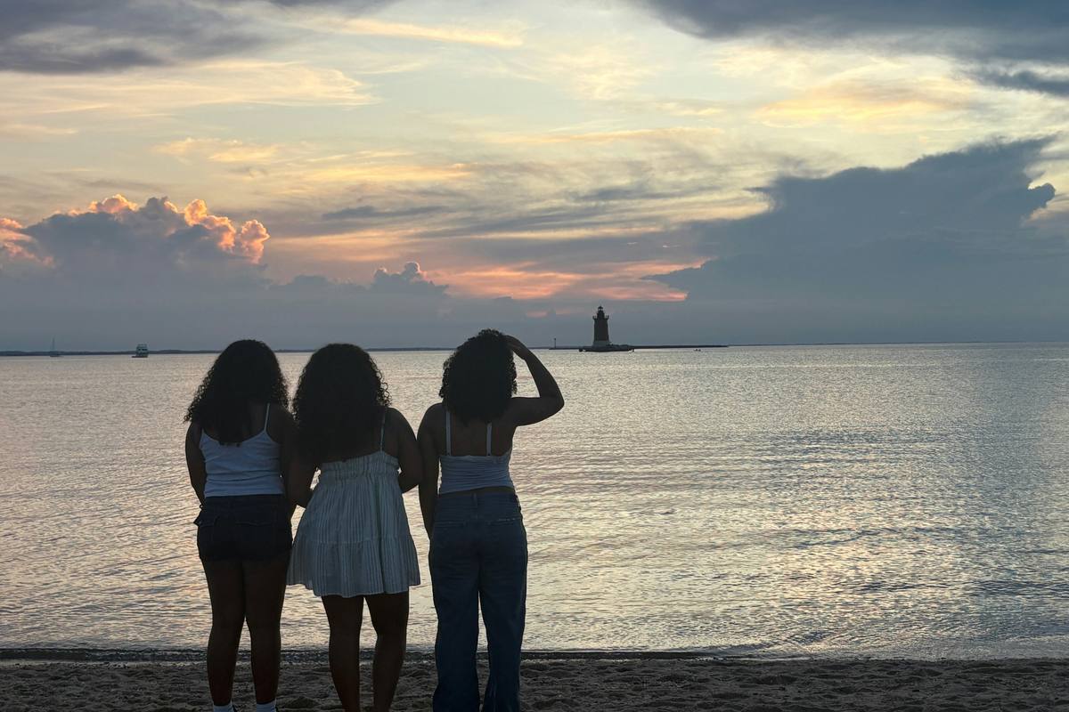 Three women at sunset looking toward the horizon — goals in midlife
