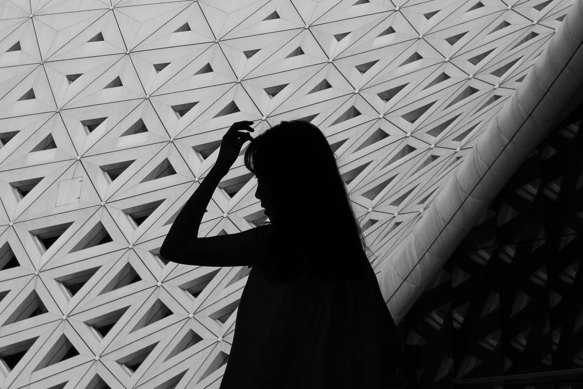 Silhouette of a woman beneath a geometric architectural lattice, symbolising the creative act of building a new chapter